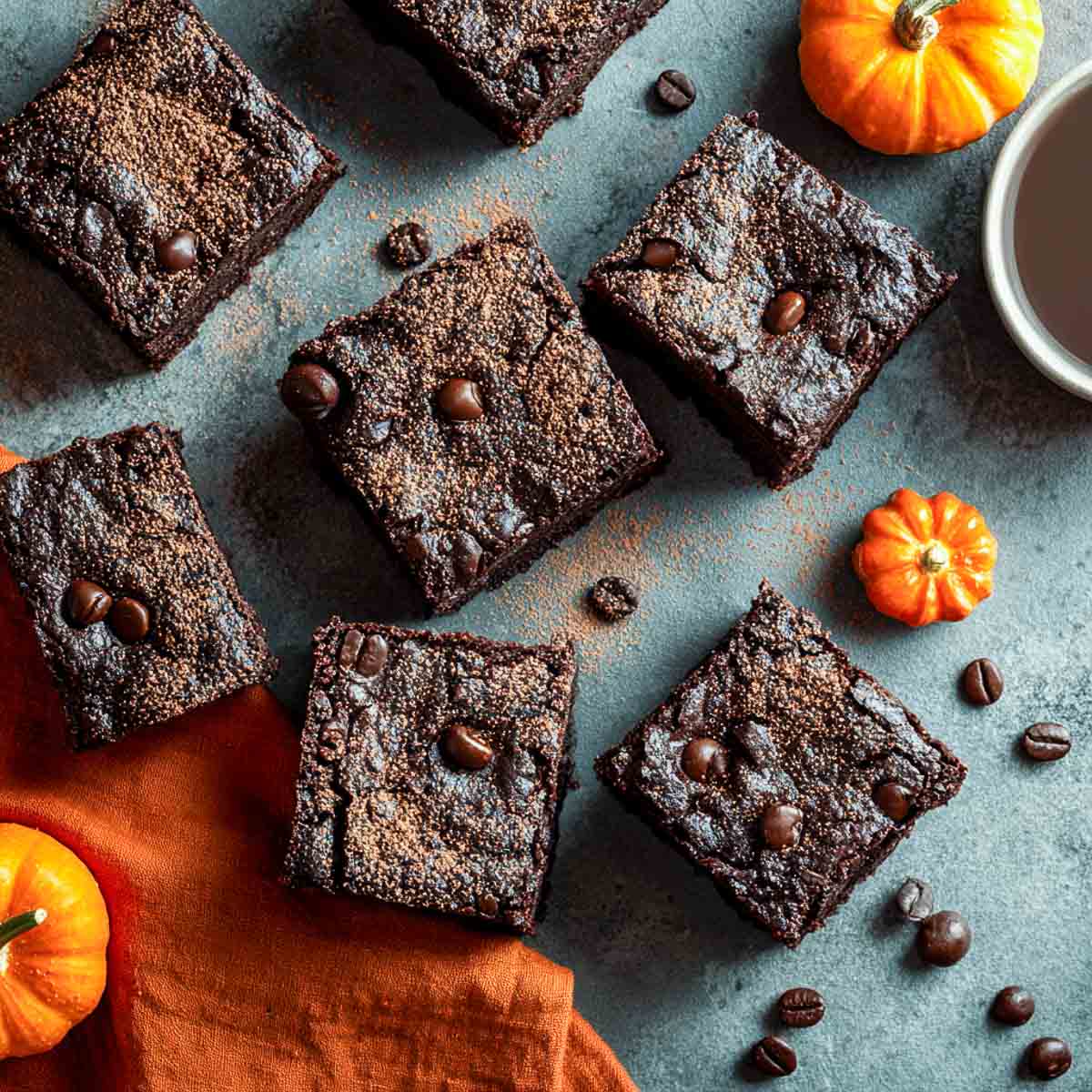 Top-down view of dark chocolate espresso brownies dusted with cocoa powder.