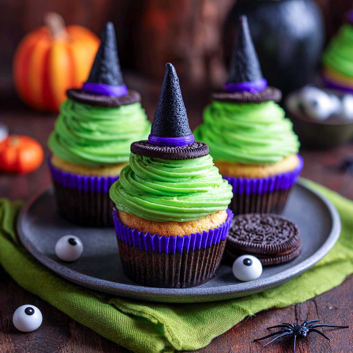 Halloween witch hat cupcakes with green frosting, Oreo brim, and chocolate cone.