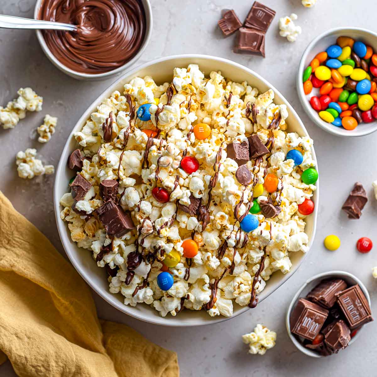 Popcorn drizzled with chocolate and sprinkled with Halloween candies.