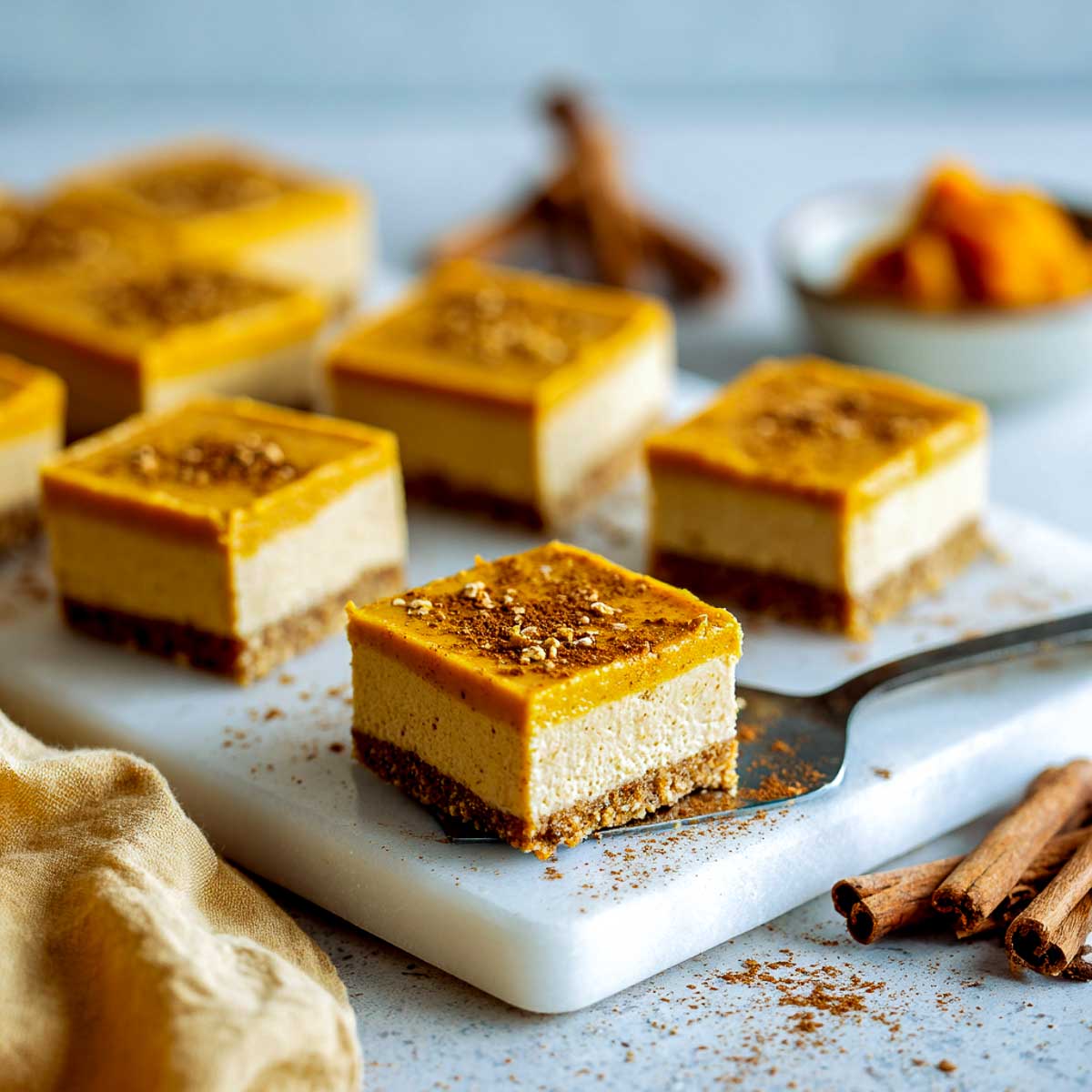 No-bake vegan pumpkin cheesecake bars with spiced crust and creamy layers.