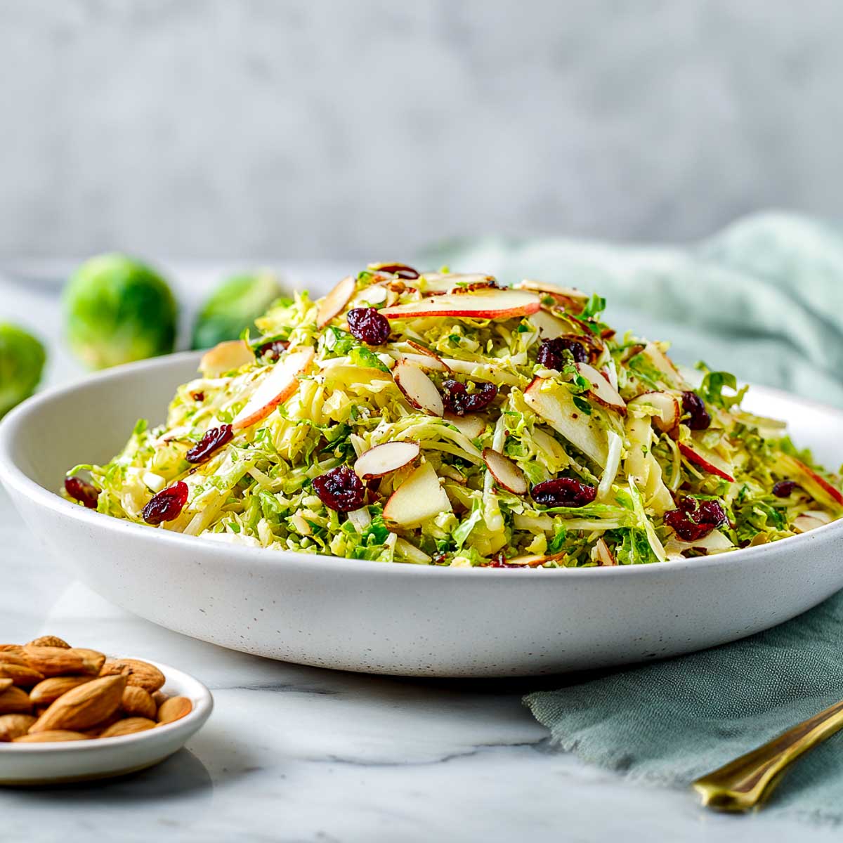 Shaved Brussels sprouts salad with apples, dried cranberries, and toasted almonds.