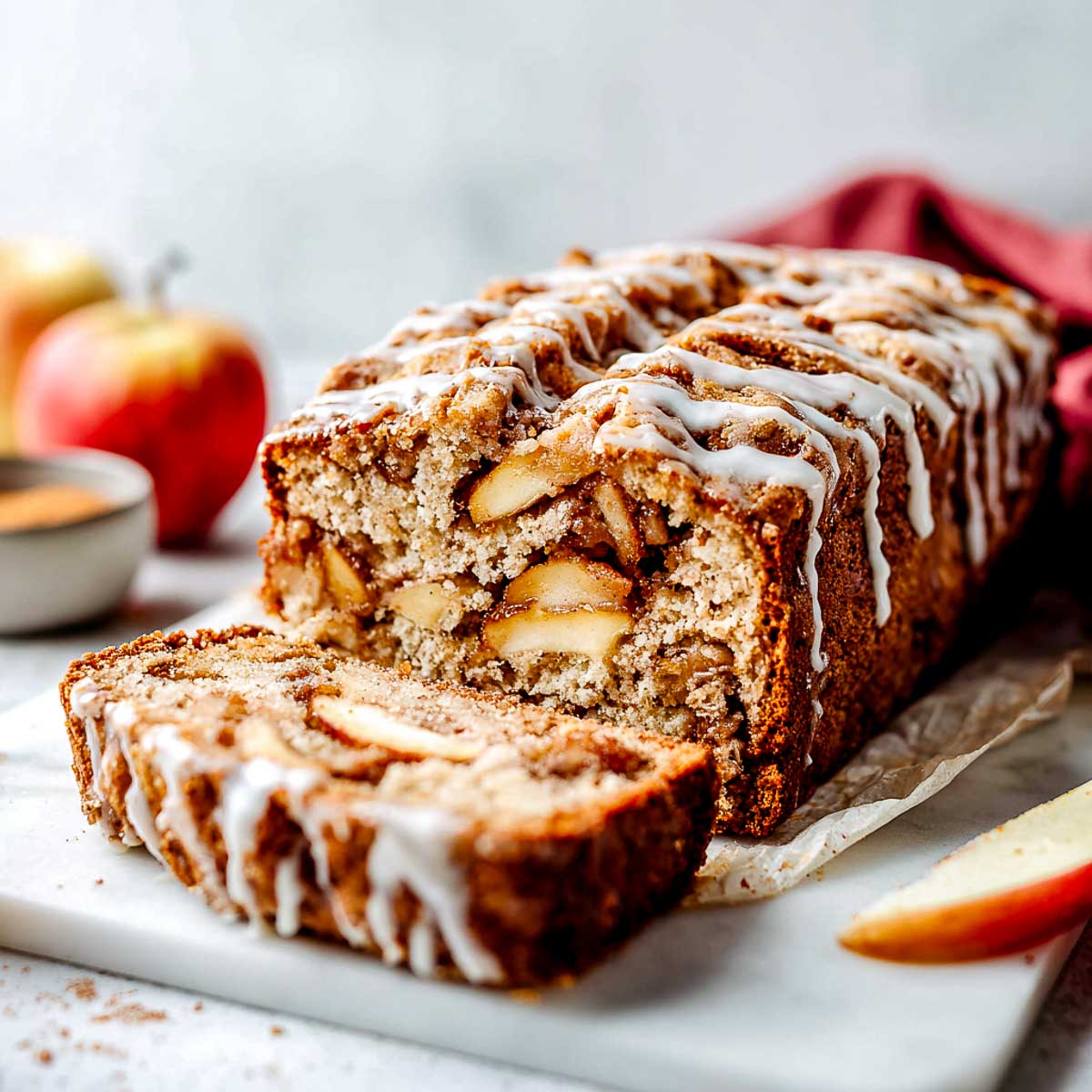 Vegan apple fritter bread with cinnamon apples and vanilla glaze.