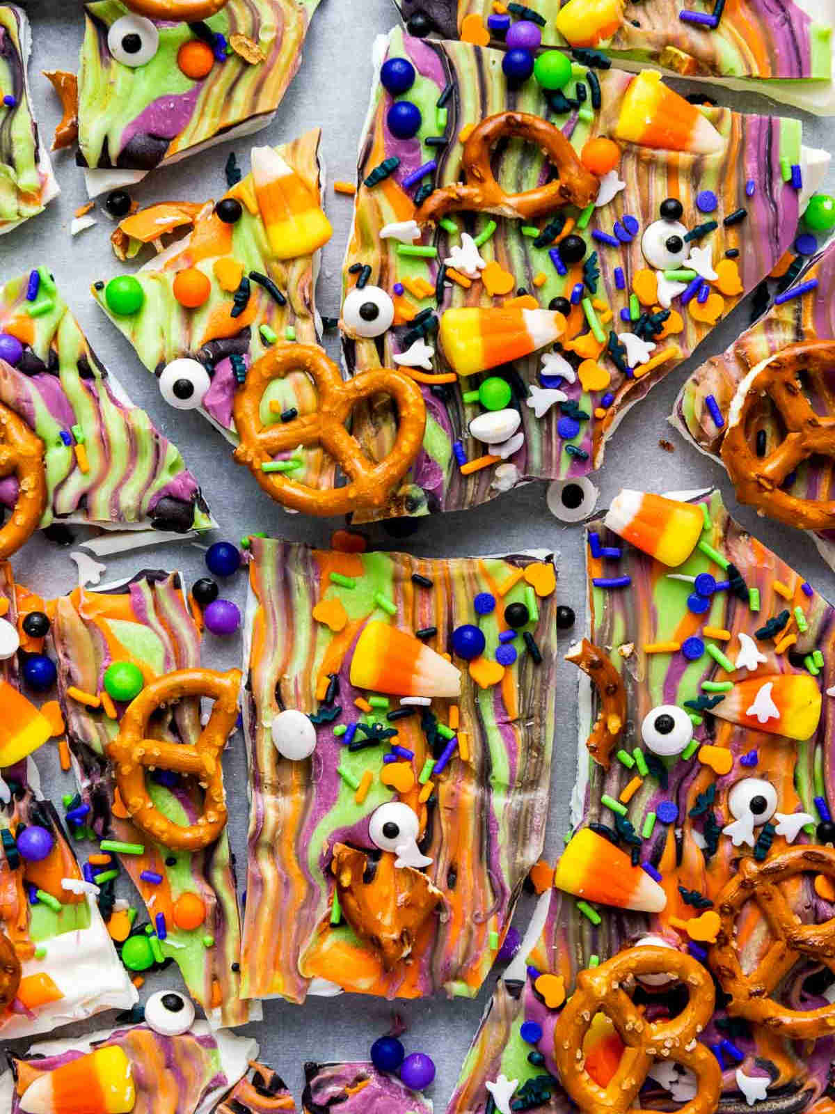 Overhead view of broken Halloween candy bark with pretzels and candy eyes.