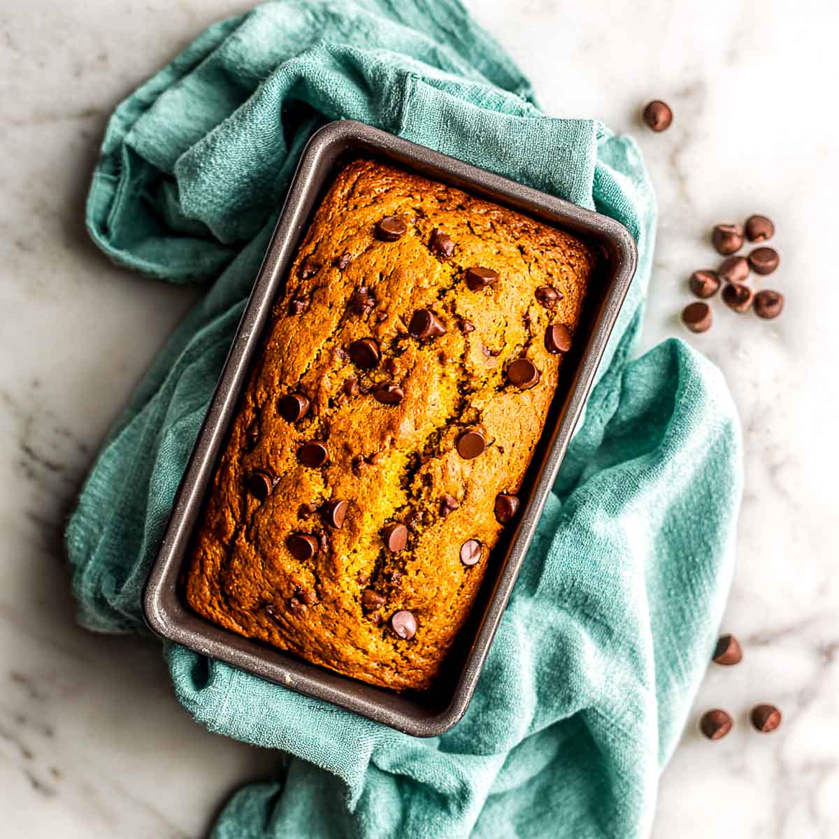 Freshly baked air fryer chocolate chip pumpkin bread in loaf pan.