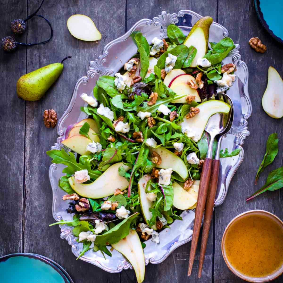 Bright and colorful fall harvest salad topped with pears, apples, walnuts, and blue cheese.