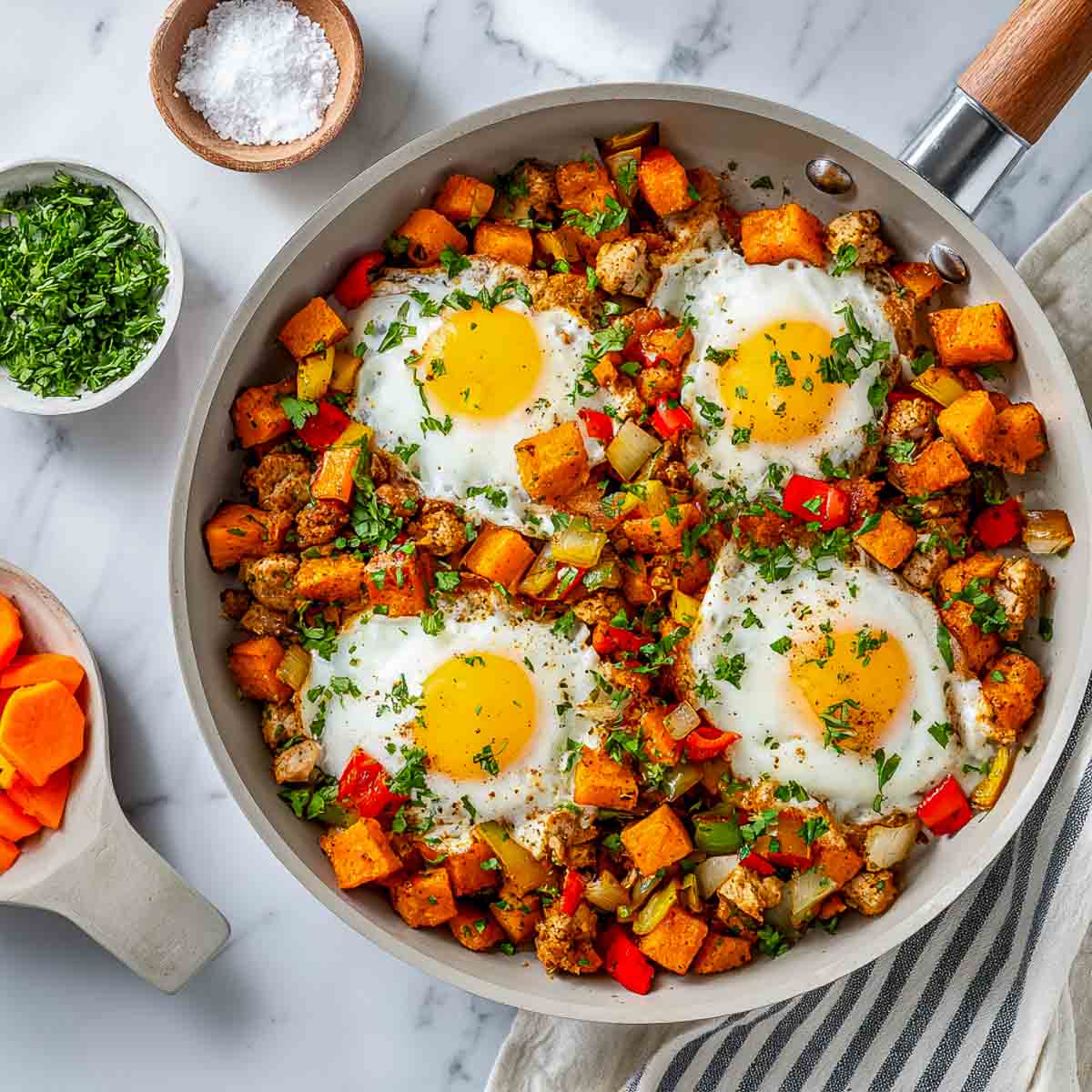 Skillet of leftover turkey and sweet potato hash with sunny side up eggs.