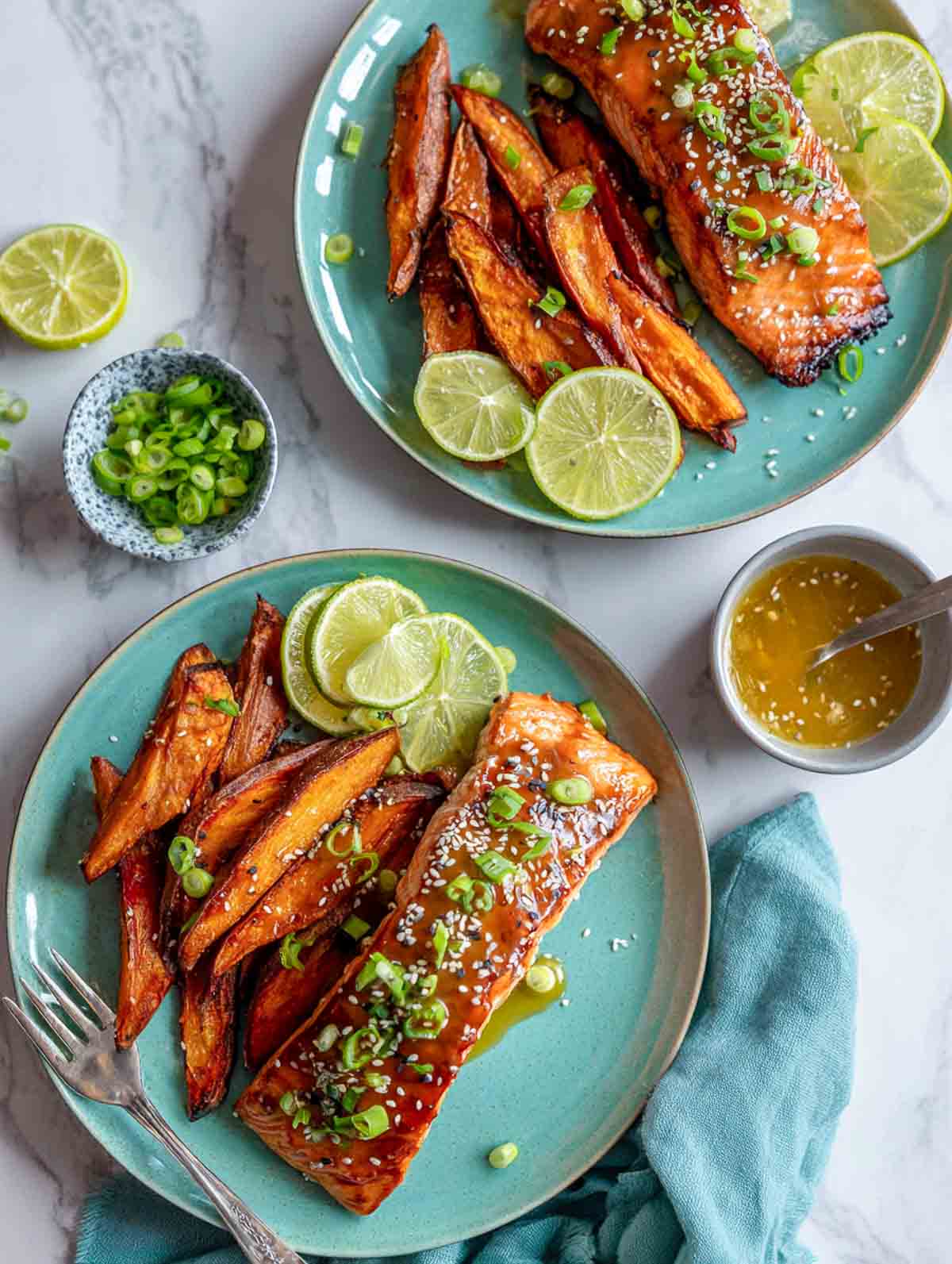 Citrus-ginger salmon with roasted sweet potato wedges served on sage green plates.