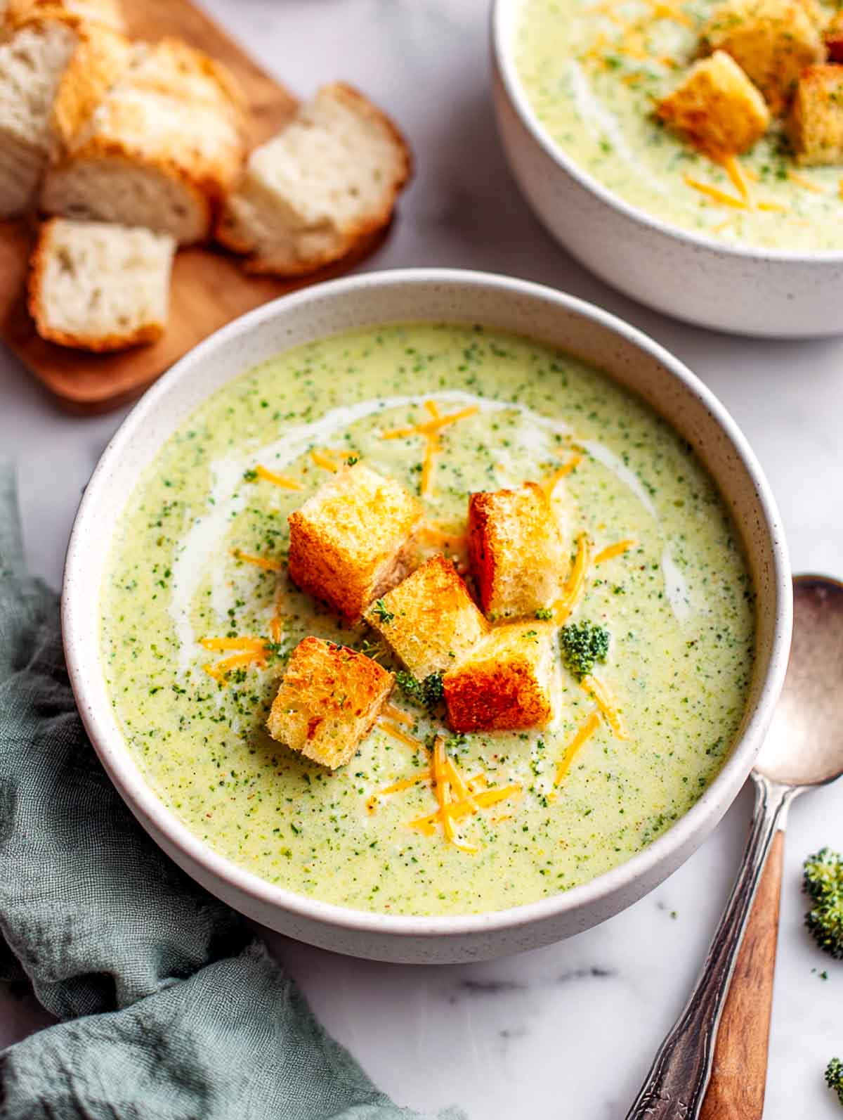 Creamy broccoli cheddar soup topped with Irish cheddar and bread pieces.