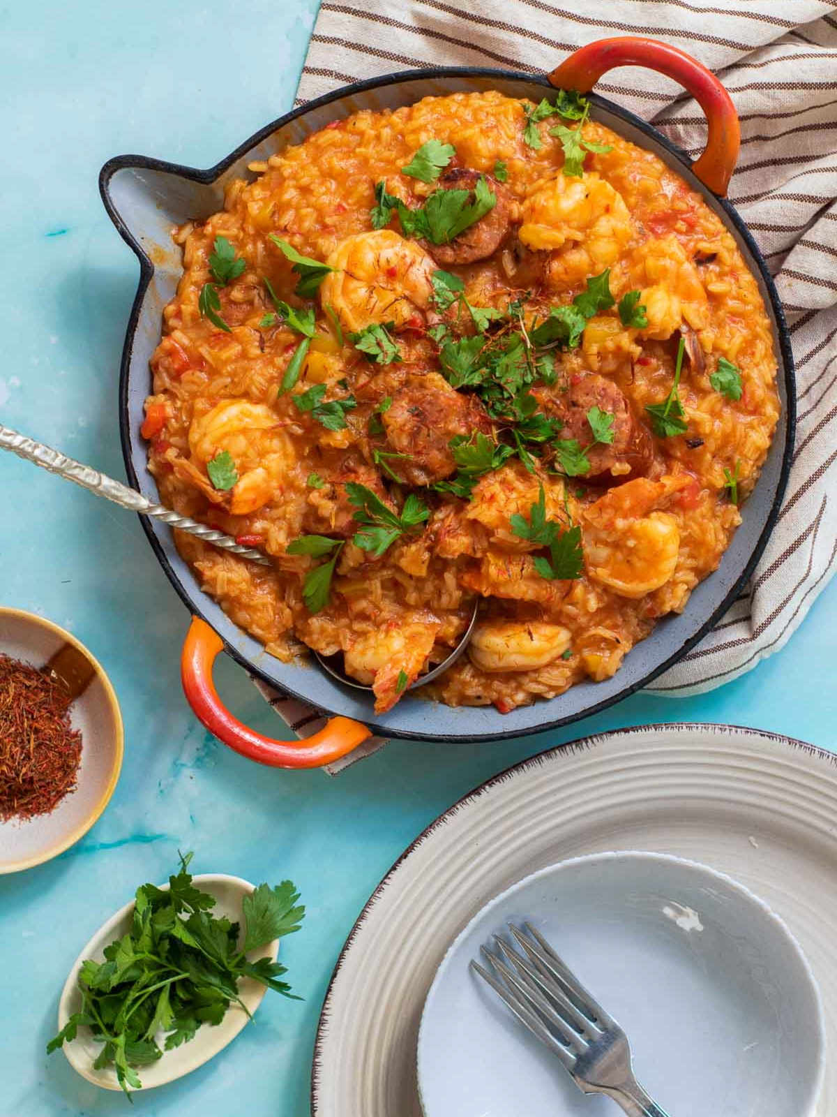 Shrimp paella made and served in a wide pan.