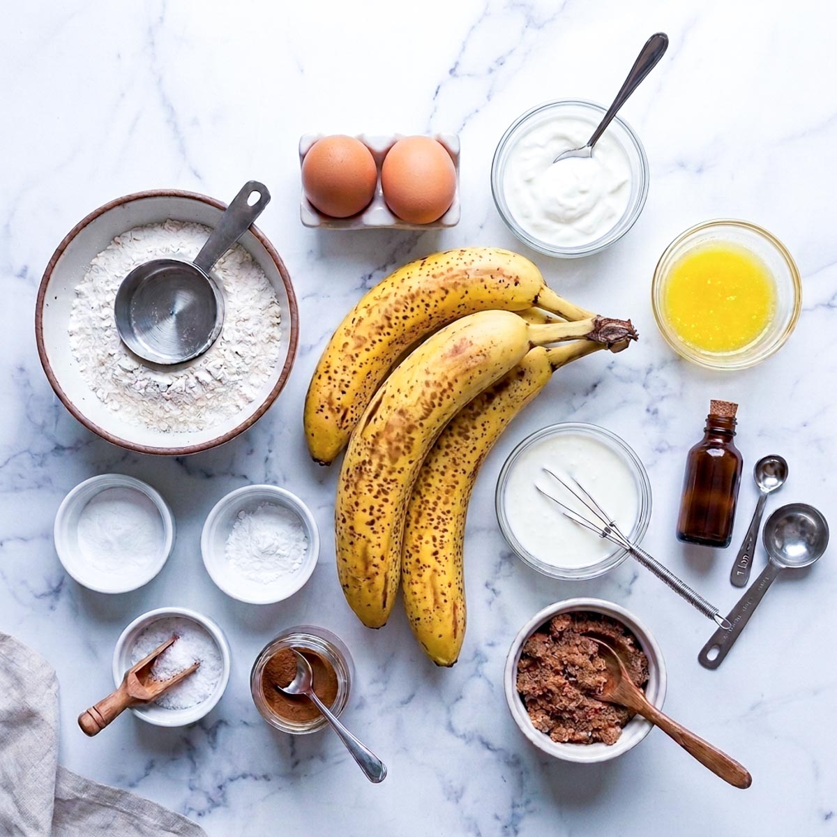 Labeled ingredients for kefir banana bread including ripe bananas, milk kefir, yogurt, eggs, flour, and cinnamon.