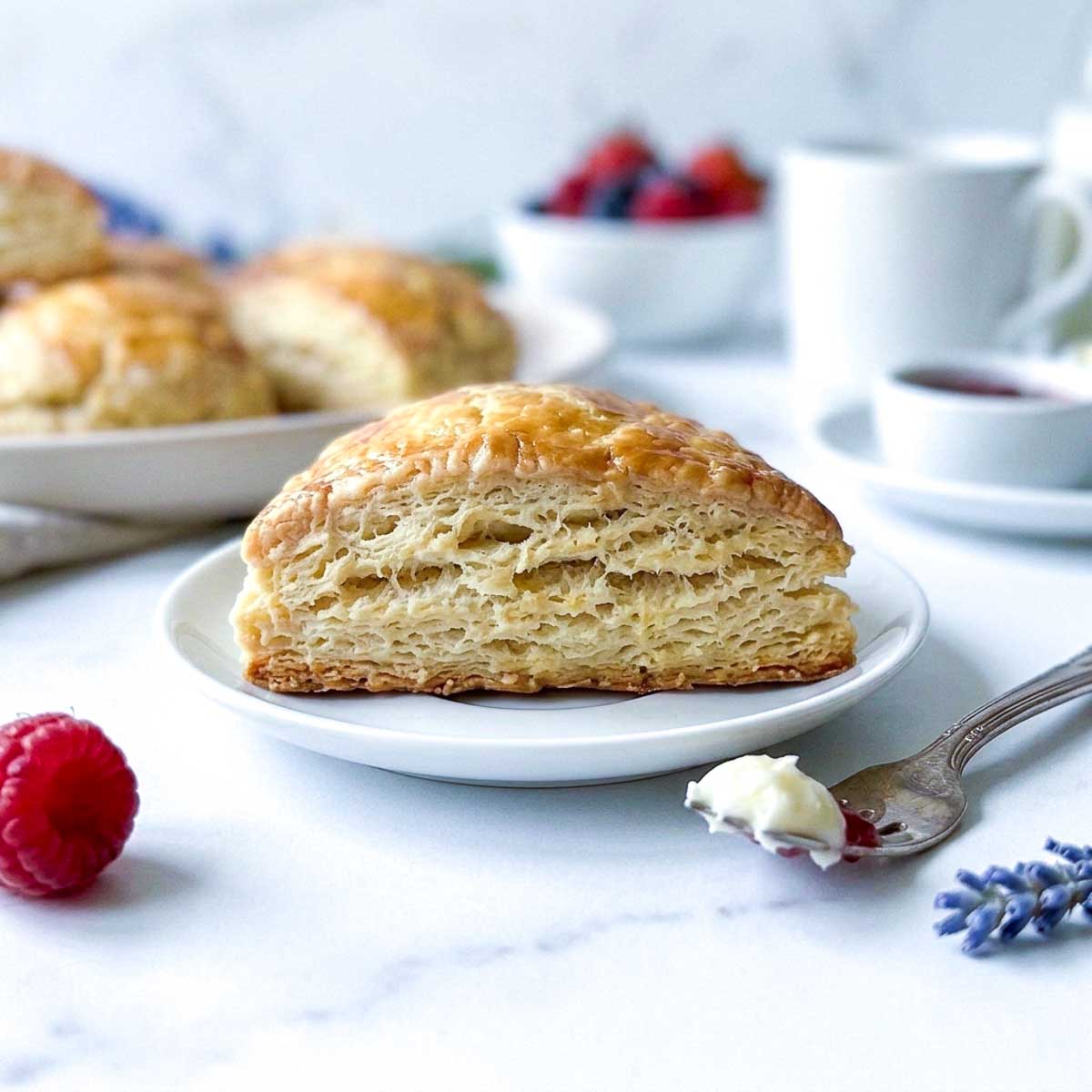 Cross section of a kefir scone showing flaky layers inside.