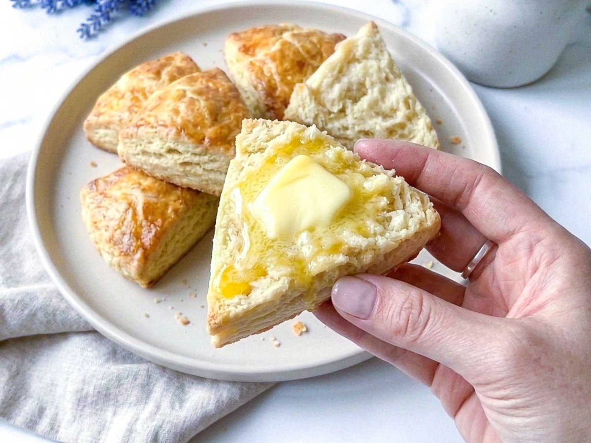 Close up of golden kefir scones showing flaky layered edges.