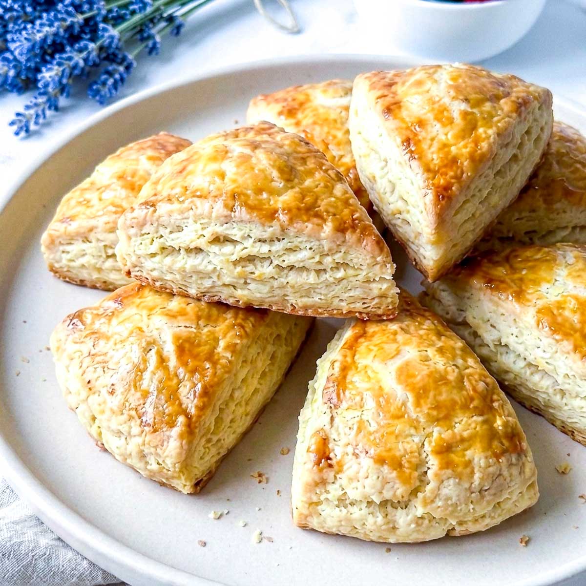 Close up of golden kefir scones showing flaky layered edges.