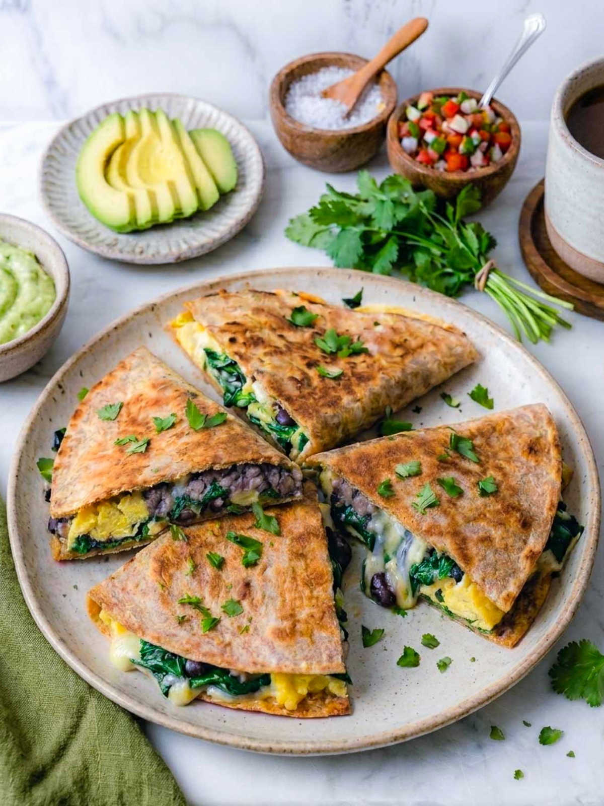 High-protein freezer breakfast quesadillas cut into wedges on a speckled plate.